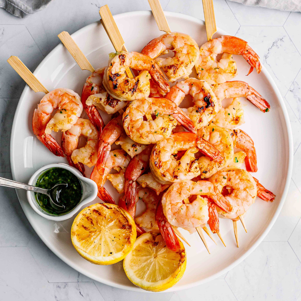 Juicy Grilled garlic prawn skewers with parsley and grilled lemon